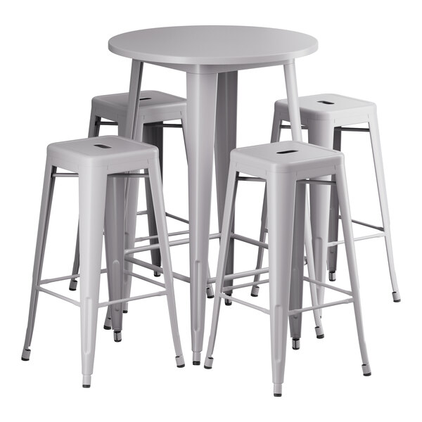 A white table with a silver edge and four white stools with legs.