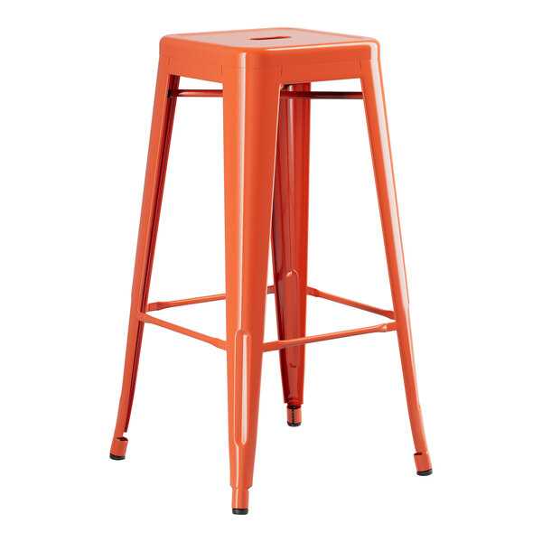 An orange metal barstool with a wooden seat.