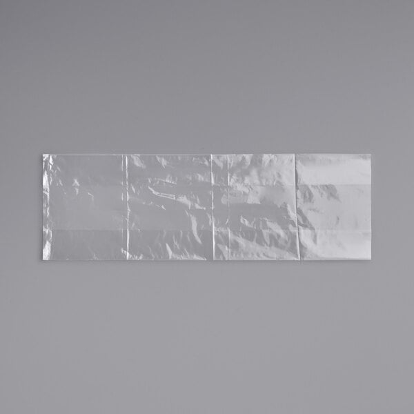 A white plastic LK Packaging food bag on a white surface with a shadow.