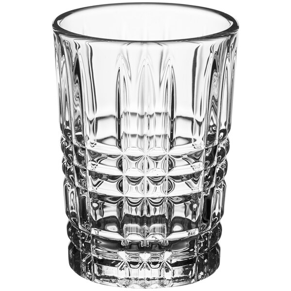 A clear Acopa shot glass with a checkered pattern.