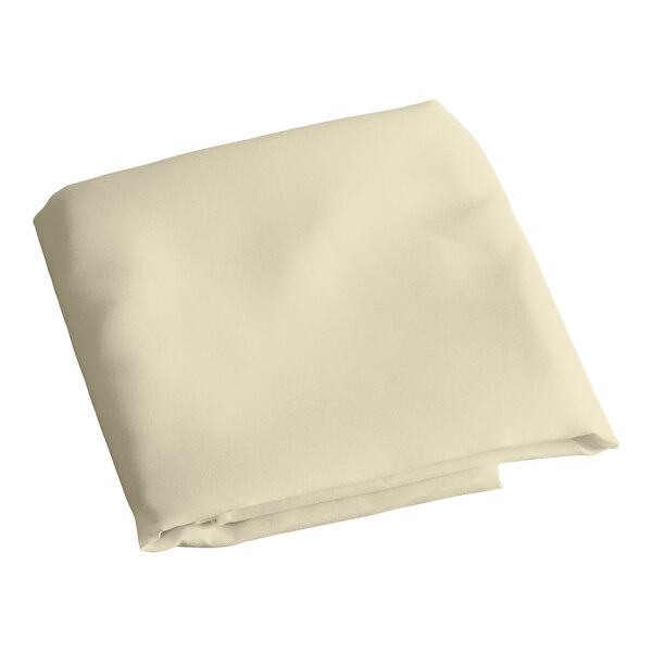 A folded ivory Intedge table cover.