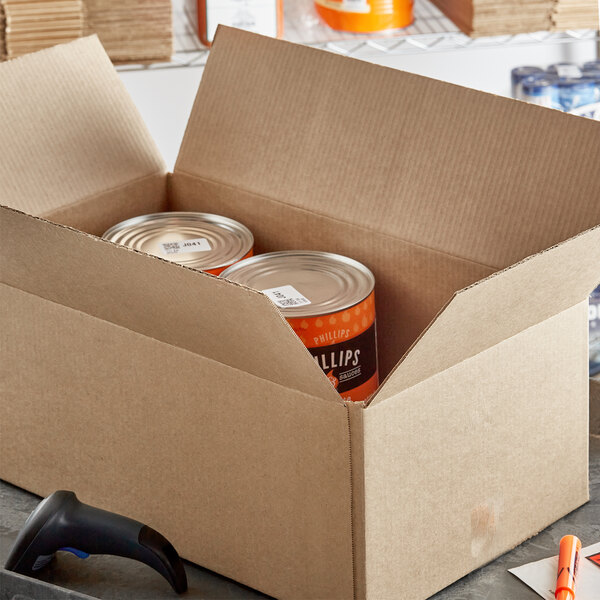 A cardboard box with cans in it.
