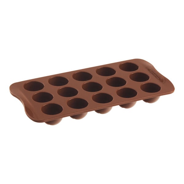 A brown silicone chocolate mold with 15 round compartments.