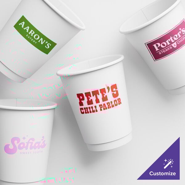 A close up of a white customizable paper hot cup with red text.