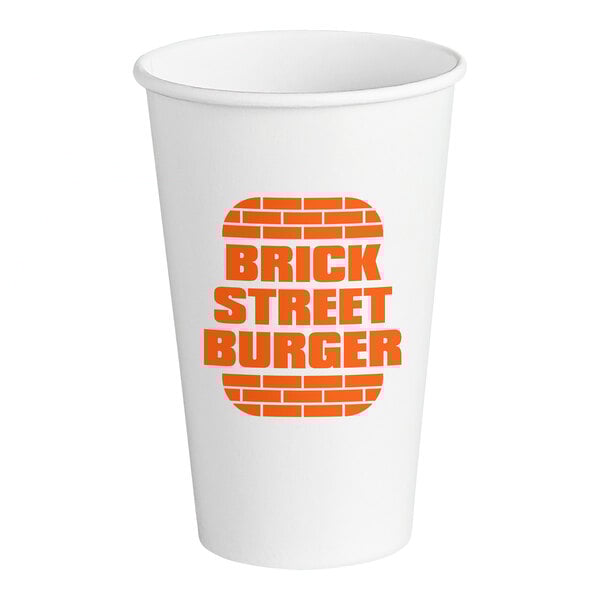 A white Customizable 16 oz. Paper Cold Cup with orange text on a logo.
