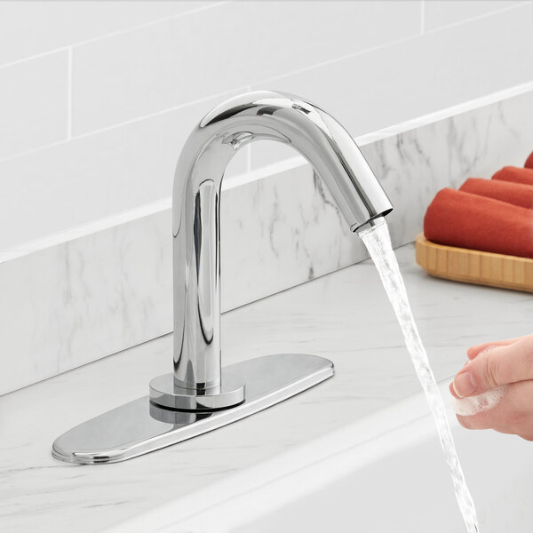 A person washing their hands under a Waterloo hands-free sensor faucet.