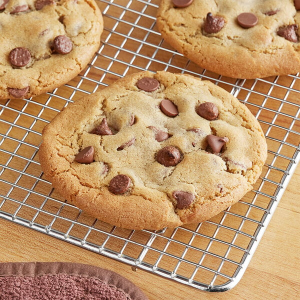 Ghirardelli milk chocolate chip cookies cooling on a rack.