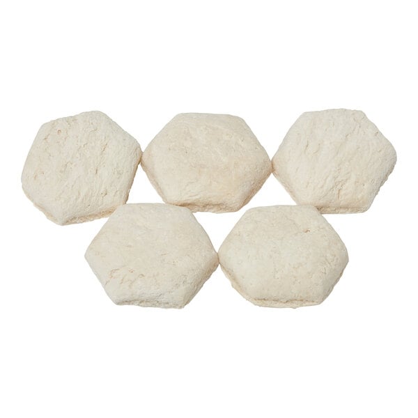 A group of white hexagonal pieces of Rich's Country-Style Biscuit dough.