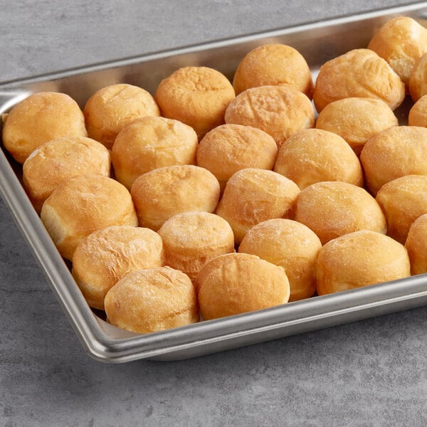 A baking pan filled with Rich's yeast-risen donut holes on a table in a hotel buffet.