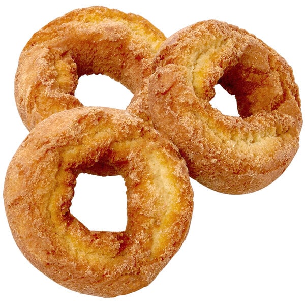 A close-up of three Rich's ready-to-finish sour cream cake donut rings.