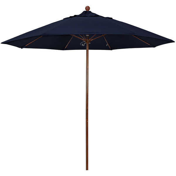 A California Umbrella with a navy blue canopy and a wooden pole.