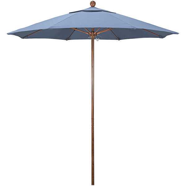 A California Umbrella blue outdoor umbrella with a wooden pole.