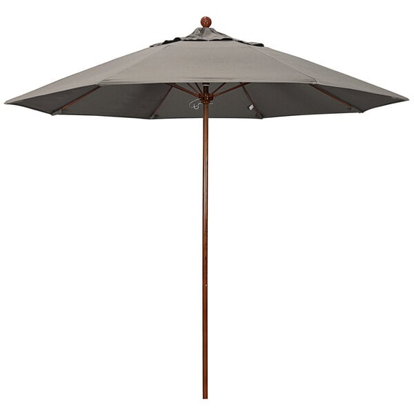 A close up of a California Umbrella with a taupe canopy and American oak pole.
