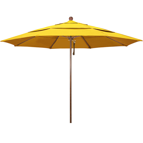 A close-up of a yellow California Umbrella with a wooden pole.