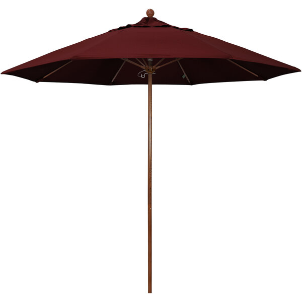 A close-up of a red California Umbrella with a wooden pole.
