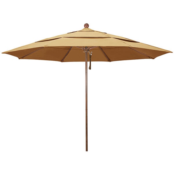 A close up of a tan California Umbrella with a wooden pole.