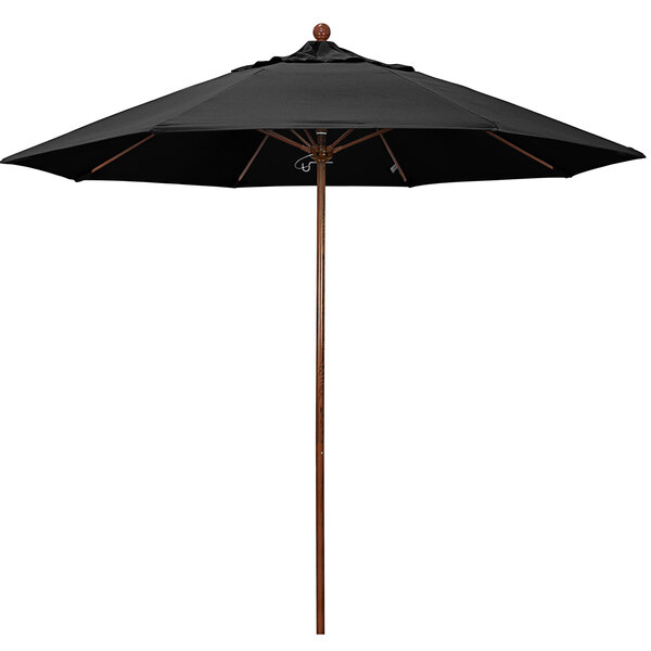 A California Umbrella black outdoor umbrella with a wooden pole.