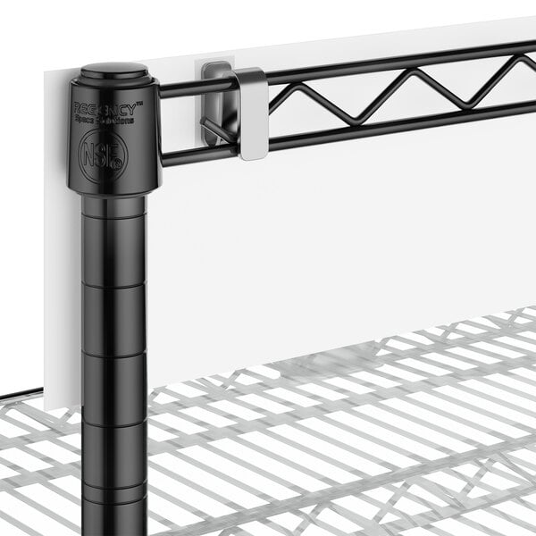 A close-up of a black post and shelf.