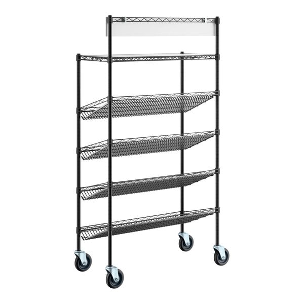 A black metal shelving unit with four slanted wire baskets, one flat shelf at the top, and four caster wheels at the base.