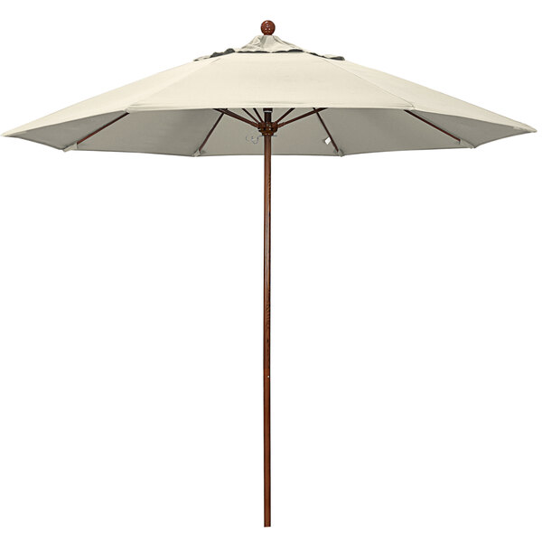 A white California Umbrella with a wooden pole.