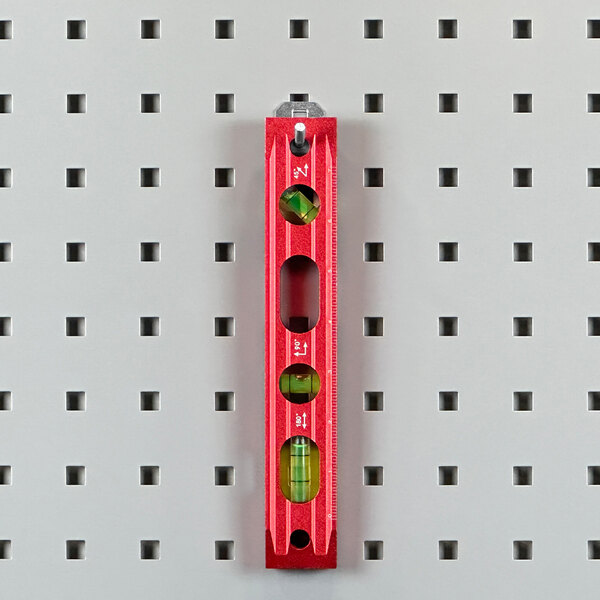 A red steel Triton LocHook with a 30 degree bend on a grey pegboard.