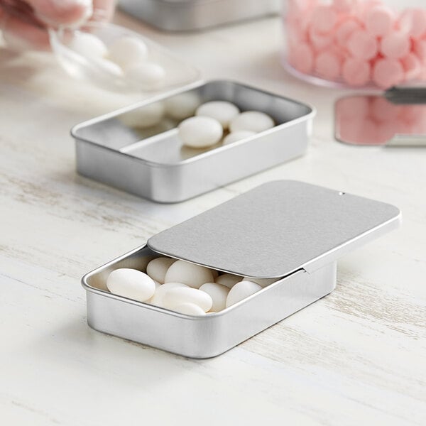A metal tin with white round objects inside.