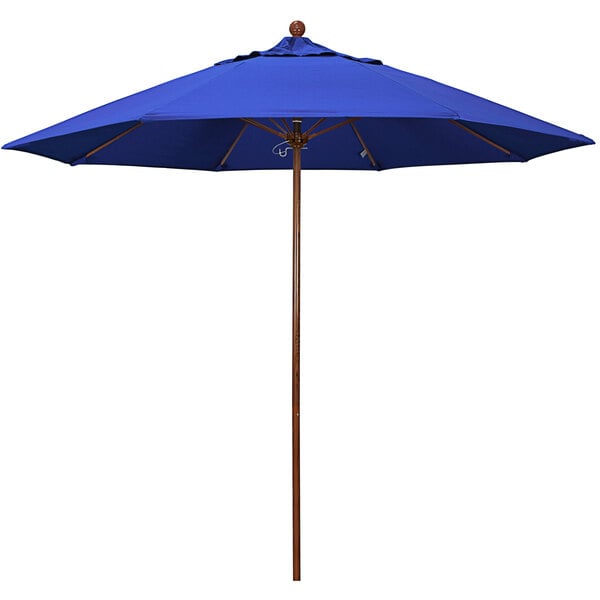 A blue California Umbrella with a wooden pole.