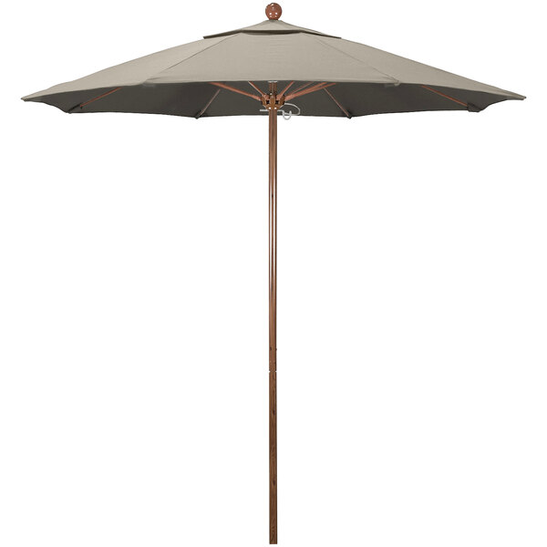 A California Umbrella with a taupe canopy on a wooden pole.