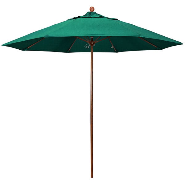 A green California Umbrella with a wooden pole.