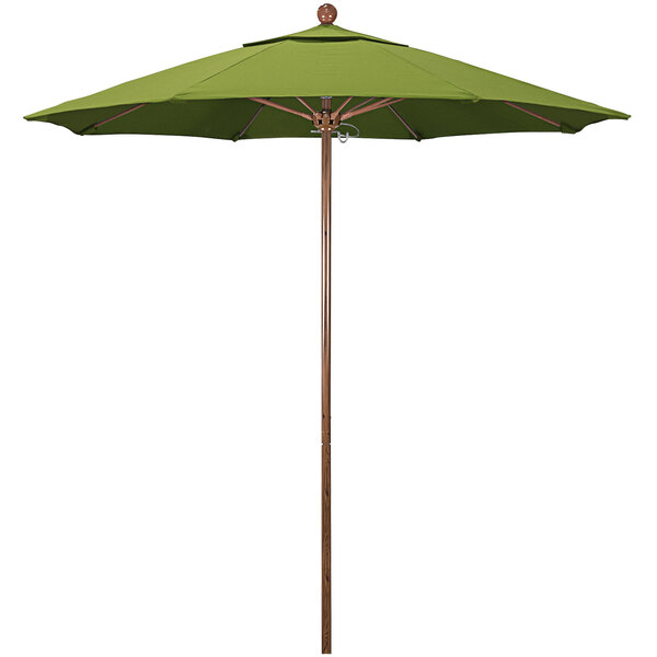 A green California Umbrella with a wooden pole and round ball on top.