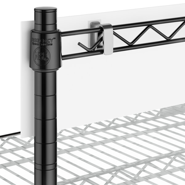 A close-up of a black post and shelf.