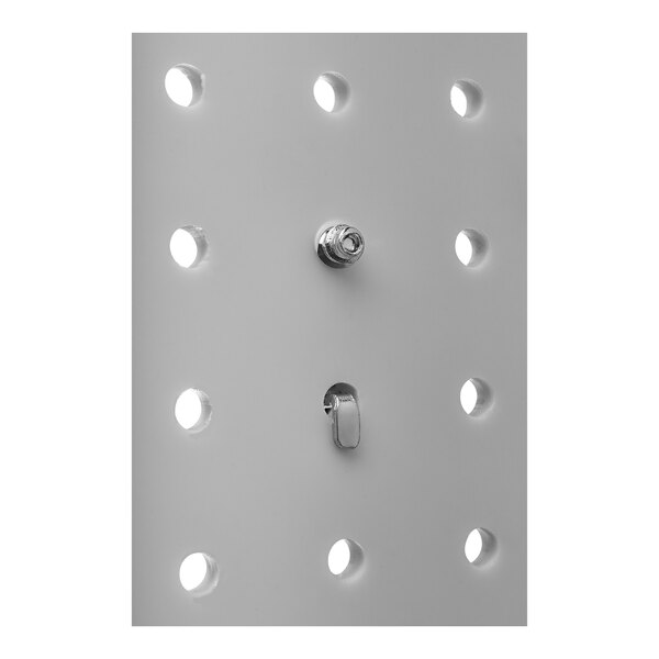 A close-up of a white metal plate with holes and a screw.