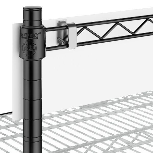 A close-up of a black post and shelf.