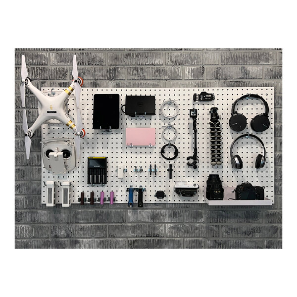 A white Triton DuraBoard with hooks and bins holding tools.