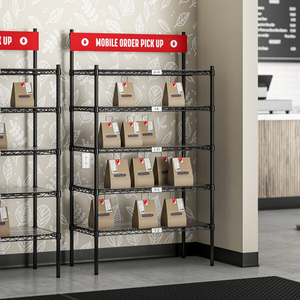 A Regency black epoxy shelving unit with PVC shelf mats holding boxes on the shelves.