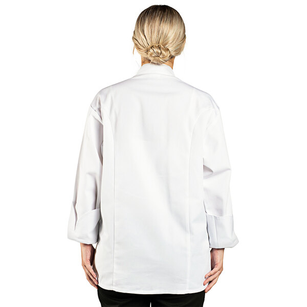 A woman wearing a white Uncommon Chef long sleeve chef coat.