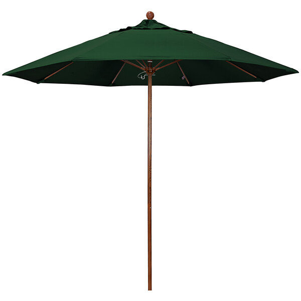 A green California Umbrella with a wooden pole.