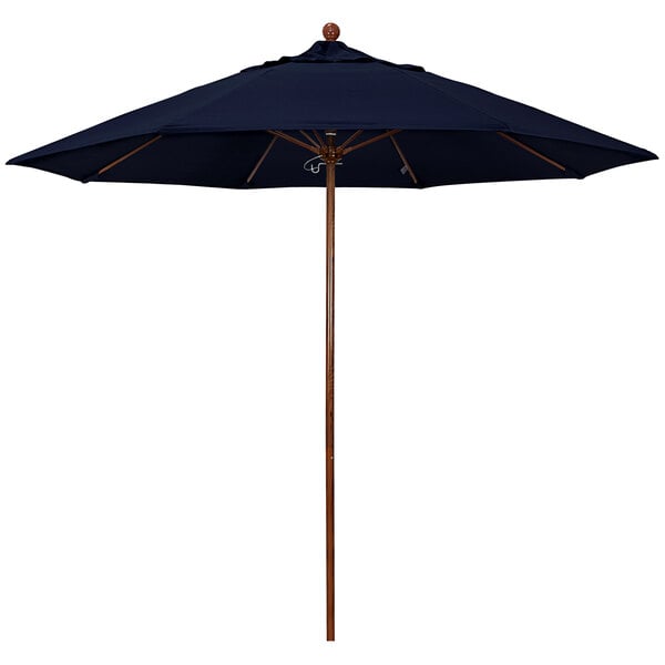 A California Umbrella Venture Series outdoor umbrella with a navy blue Pacifica canopy and an American oak pole.