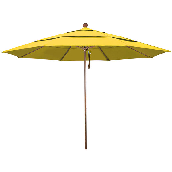 A yellow California Umbrella with a wooden pole.