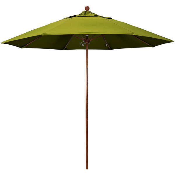 A green California Umbrella with a brown wooden pole.