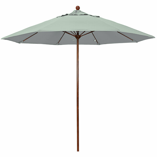 A close-up of a California Umbrella with a Pacifica Spa green canopy.