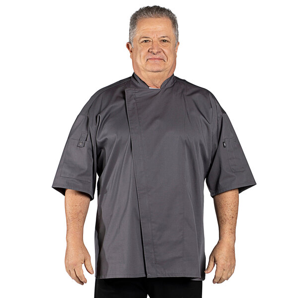 A man wearing a slate gray Uncommon Chef Venture Pro Vent chef coat.