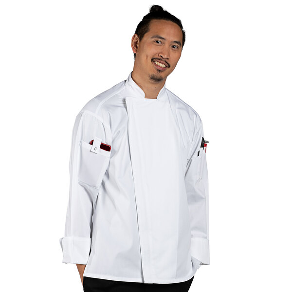 A man in a white Uncommon Chef long sleeve chef coat with mesh back posing for a photo.