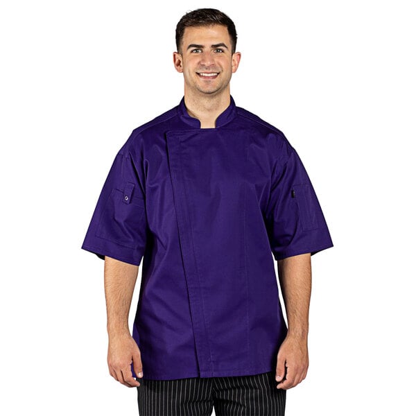 A man wearing a purple Uncommon Chef Venture Pro chef coat with a mesh back.