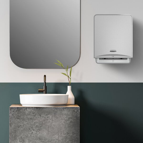 A Kimberly-Clark Professional ICON Automatic Paper Towel Dispenser with a silver mosaic faceplate on a white surface.