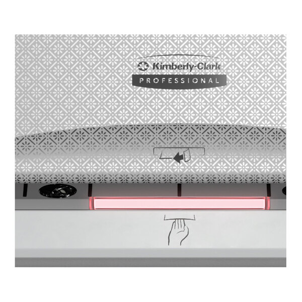 A close-up of a Kimberly-Clark Professional ICON Automatic Paper Towel Dispenser with a silver and black faceplate.
