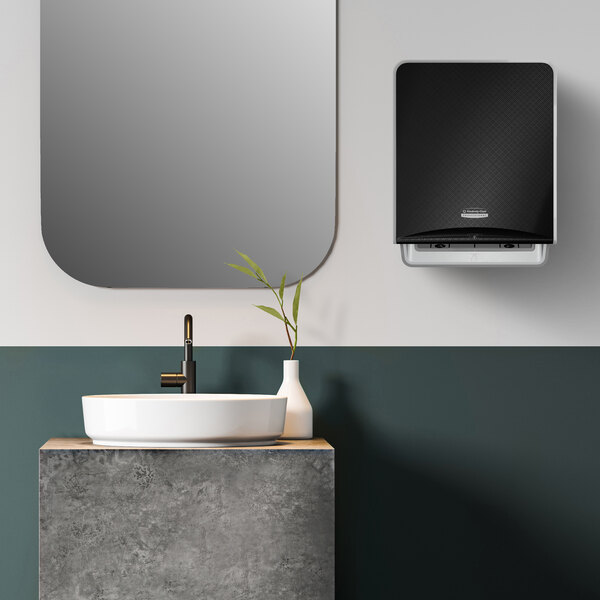 A Kimberly-Clark Professional ICON automatic paper towel dispenser with a black mosaic faceplate on a white surface.