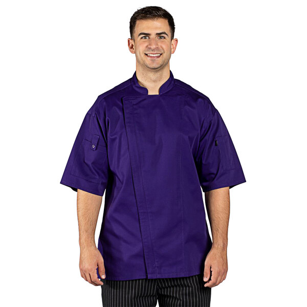 A man wearing a purple Uncommon Chef short sleeve chef coat with a mesh back.