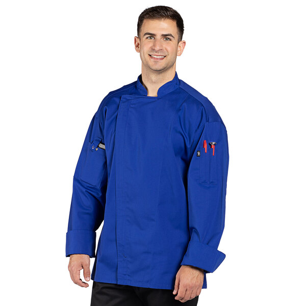 A man wearing a deep royal blue Uncommon Chef long sleeve chef coat with a mesh back.