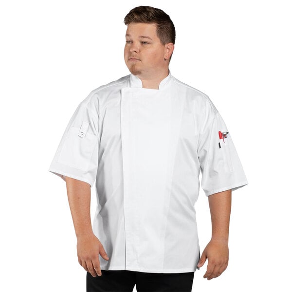 A man wearing a white Uncommon Chef Venture Pro short sleeve chef coat with a mesh back.